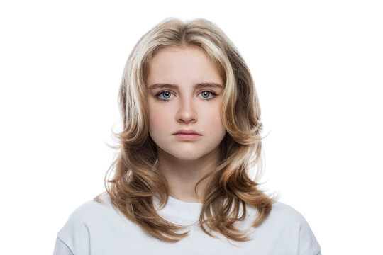 Serious teenage girl in a white T-shirt. Thought, stress and problems. Isolated on a white background. Close-up.