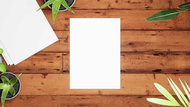 Mockup white paper on the wooden brown table background with tropical house plants ,top view
