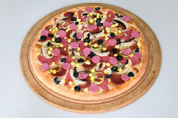 Delicious mixed pizza with rich content. Menu concept of choice and diversity