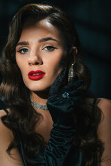 Portrait of brunette woman in classic retro style. Beautiful girl with a hairstyle and makeup with...