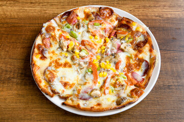 Delicious mixed pizza with rich content. Menu concept of choice and diversity