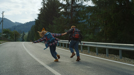 Lovers dancing around forest nature on mountains road. Couple hold hands outside