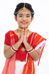 Portrait of beautiful bengali girl greeting in traditional red and white sari with jewelry
