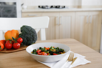 Tasty salad with steamed broccoli and fresh tomatoes in a white ceramic bowl. Clean eating concept. Healthy vegan dish made of organic vegetables. Close up, copy space, background.