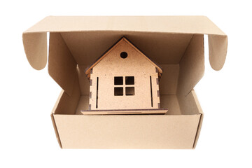 Toy house in a cardboard box on white