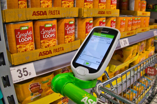 A bar code scanner in a holder on a supermarket trolley in an ASDA store in the UK - used by customers to scan barcodes on goods they want to buy for a quick checkout