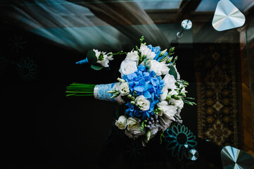 Wedding bouquet of the bride of blue and white flowers and greens, stylish elegant buttonhole groom...