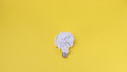 paper light bulb on yellow background