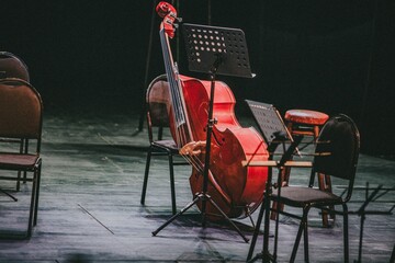 Red cello with chairs and music stands on a symphony orchestra stage