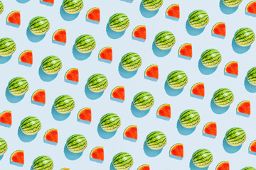 Watermelons, summer fruit, creative pattern on pastel blue background. Summer refreshment concept. 
