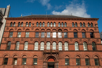 Red sandstone facade view of the Italian Gothic style 19th century former Water Office warehouse on Donegall Square, Belfast, Northern Ireland, UK