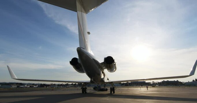 Slow Motion Lockdown Of A Sleek Modern Jet As It Backs-Up On An Airport Tarmac - Los Angeles, California