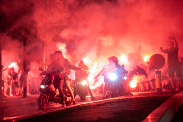 Red Star Football fans with torches and flags marching on streets and celebrating league title win...