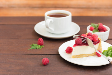 Raspberry pie (cheesecake) made from fresh raspberries with tea on a wooden background. Copy space