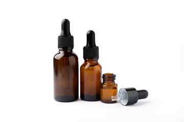 Essential oil in a glass bottle with a pipette. Bottle with fragrant oil isolated on white background. essential oil mockup with copy space. serum.