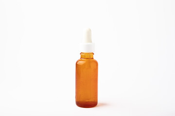 Essential oil in a glass bottle with a pipette. Bottle with fragrant oil isolated on white background. essential oil mockup with copy space. serum.