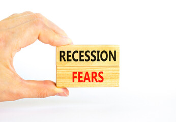 Recession fears symbol. Concept words Recession fears on wooden blocks on a beautiful white table white background. Businessman hand. Business and recession fears concept. Copy space.