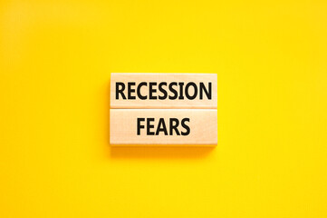 Recession fears symbol. Concept words Recession fears on wooden blocks on a beautiful yellow table yellow background. Business and recession fears concept. Copy space.