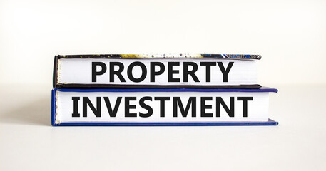 Property investment symbol. Concept words Property investment on books on a beautiful white table white background. Business Property investment concept. Copy space.