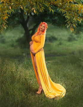 fantasy photo pregnant woman queen hugs bare belly. Pregnancy outfit creative design ancient vintage greek style elegant yellow dress. Gold wreath crown on head. Goddess of fertility. summer nature
