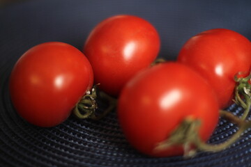 Red ripe tomatoes ondark background
