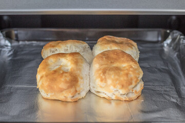 Freshly baked biscuits on baking pan.