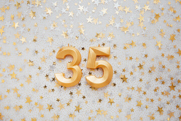 Number 35 thirty five golden celebration birthday candle on Festive Background. thirty five years birthday. concept of celebrating birthday, anniversary, important date, holiday
