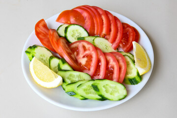 Green salad with arugula, lamb and tomatoes. Healthy vegan dish. Top view at table. Turkish Coban (choban) salata or Shepherds salad, Akdeniz salad in white bowl.