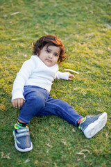 Fototapeta premium Little boy playing on grass.