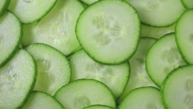 closeup of freshly cut cucumber slices rotating