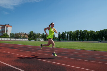 Fototapeta premium woman runs in the stadium.