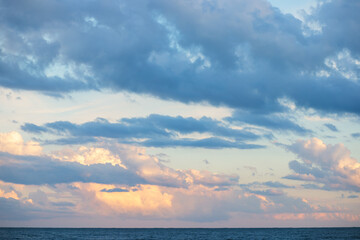 sky blue on the sea background, fluffy clouds in sunlight