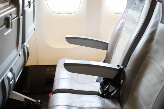 aircraft cabin interior, empty passenger seats inside close up