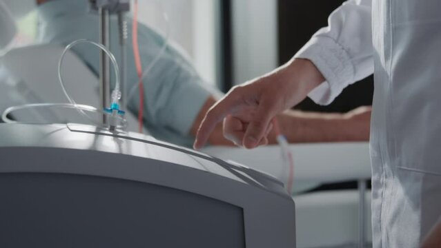 Close up hands female nurse use machine for blood. Man donates blood. Medicine. In hospital room. Healthcare. Slow m otion