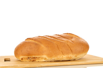 One fragrant fresh loaf on a wooden cutting board, close-up, isolated on a white background.