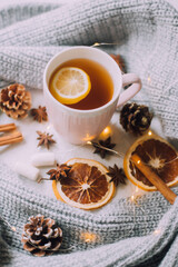 New Year's tea with a garland and oranges . Christmas mood. A cold evening. Hot drinks.