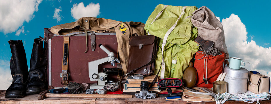 Vintage set of equipment for field geological work against a blue sky with clouds
