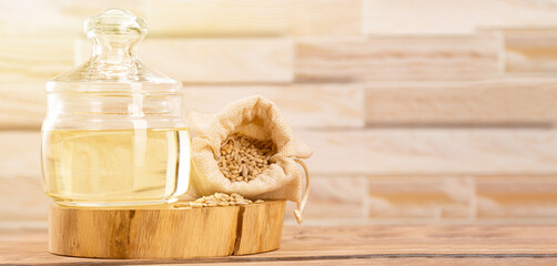 Peeled sunflower seeds in a bag next to sunflower oil in a glass bowl with background for text or copy space