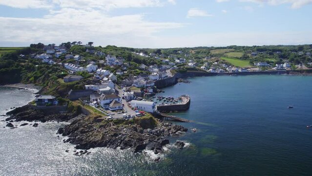 Aerial shot of Coverack fishing village , harbour and lifeboat slipway on summer day