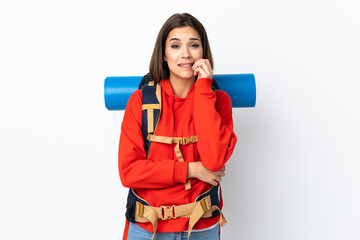 Young caucasian mountaineer girl with a big backpack isolated on white background nervous and scared