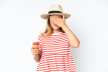 Obraz na płótnie Canvas Young caucasian woman holding a cornet ice cream isolated on white background covering eyes by hands. Do not want to see something