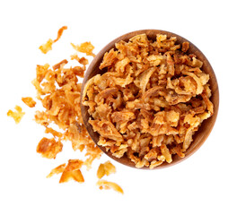 Roasted onions in wooden bowl, isolated on white background. Crispy fried onions. Top view.