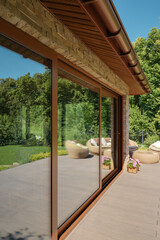 Large sliding glass windows of the summer terrace. Country house in the garden.