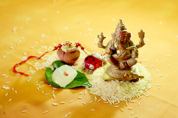 Indian festival: Raksha Bandhan. A traditional Indian wrist band on yellow background.