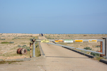 Boom barrier with restricting signs in the middle of a desert road © Wirestock Creators
