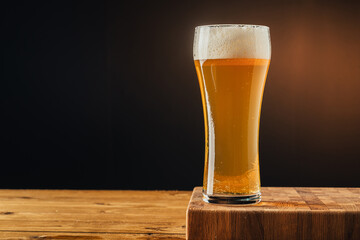 Glass beer on wood background with copyspace