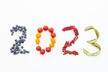New year 2023 made of fruits on the white background. Healthy food
