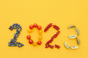 Happy New Year 2023 number made of fruits and berries