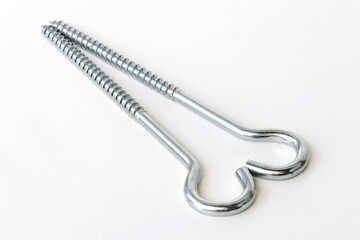 two hook screws on a white background, in the form of a heart, close-up