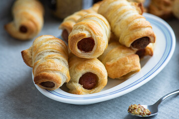 Pigs in a blanket - mini sausage roll on a plate.